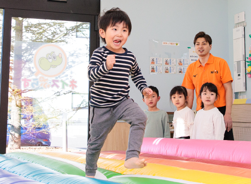 子どもがマットの上でジャンプして運動している様子